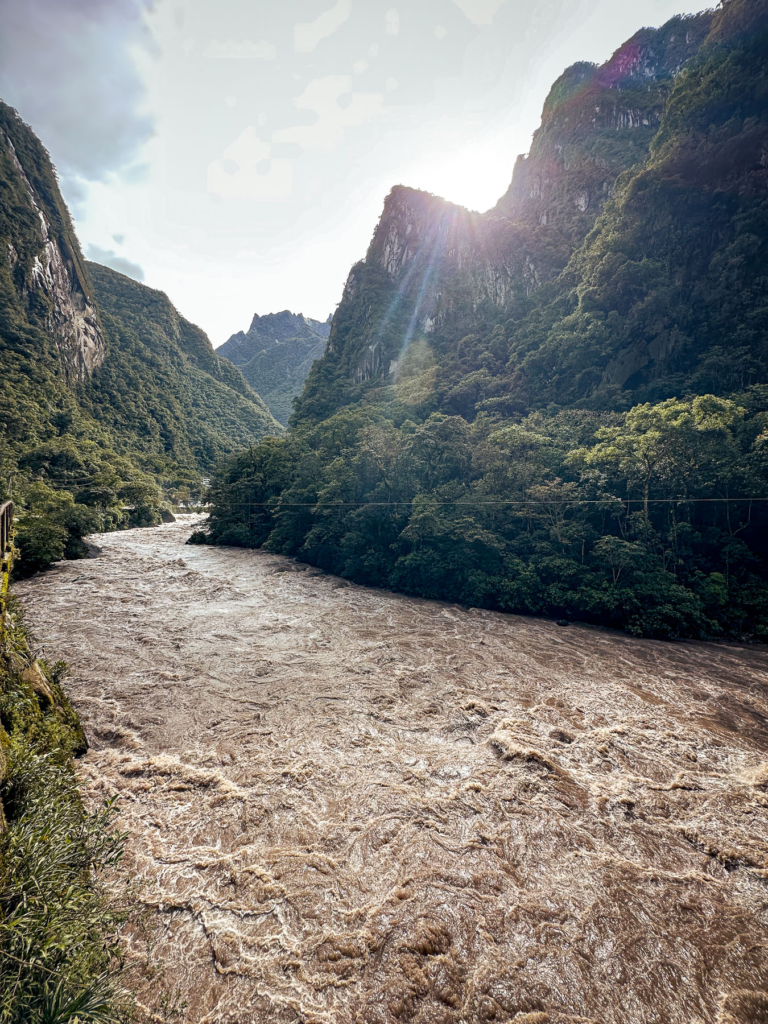 The Urubamba River running through a green valley at sunset near Machu Picchu