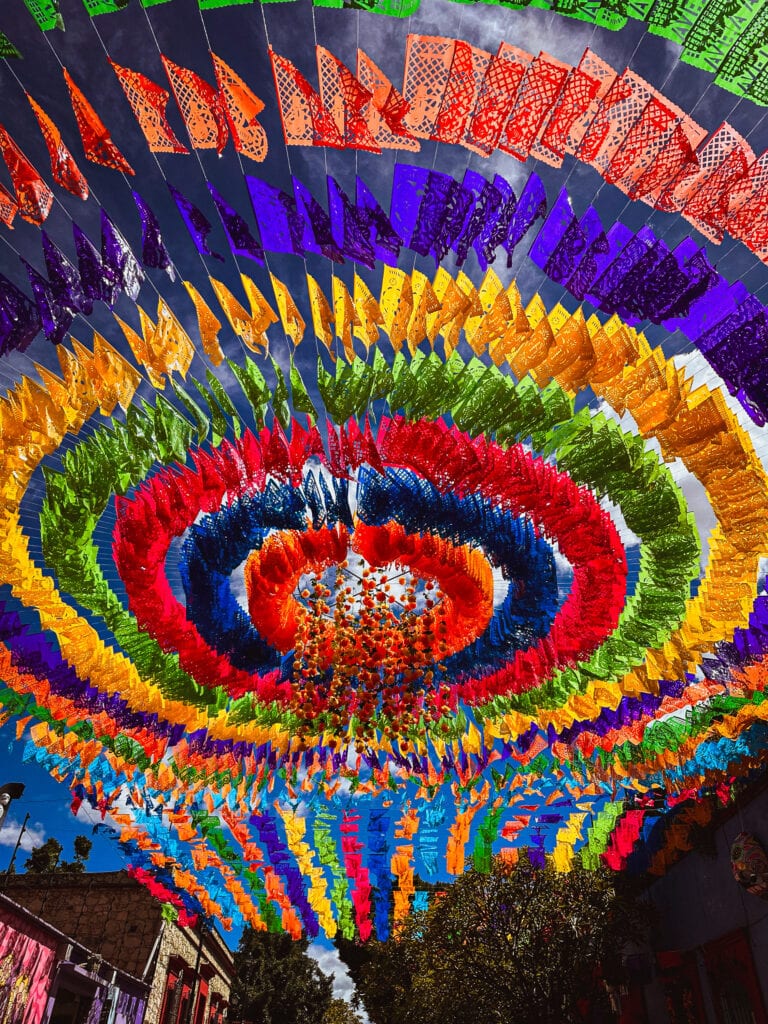 Colourful papel picado above a street in Jalatlaco Oaxaca Mexico during Día de los Muertos